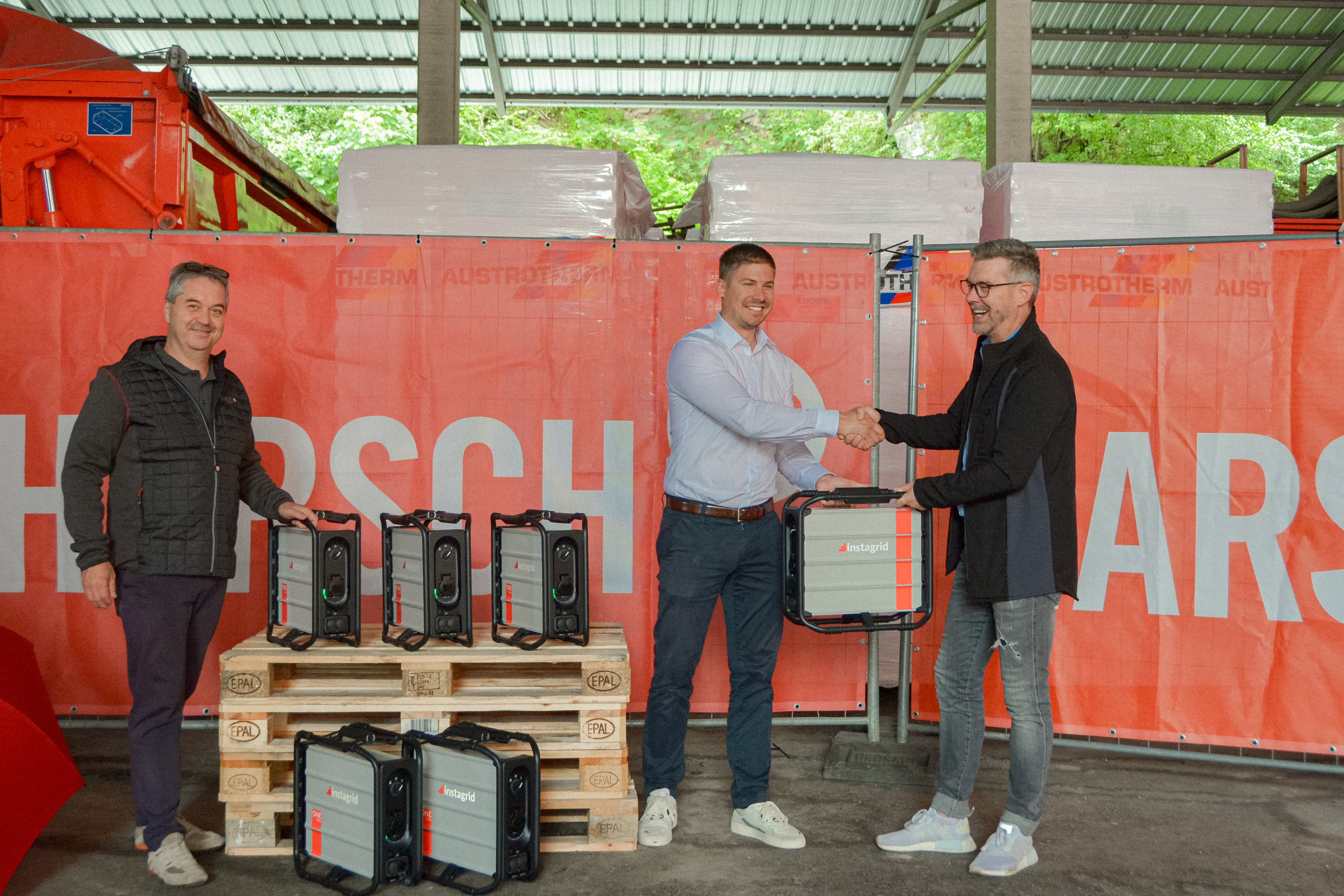 Harsch management team shaking hands with instagrid people